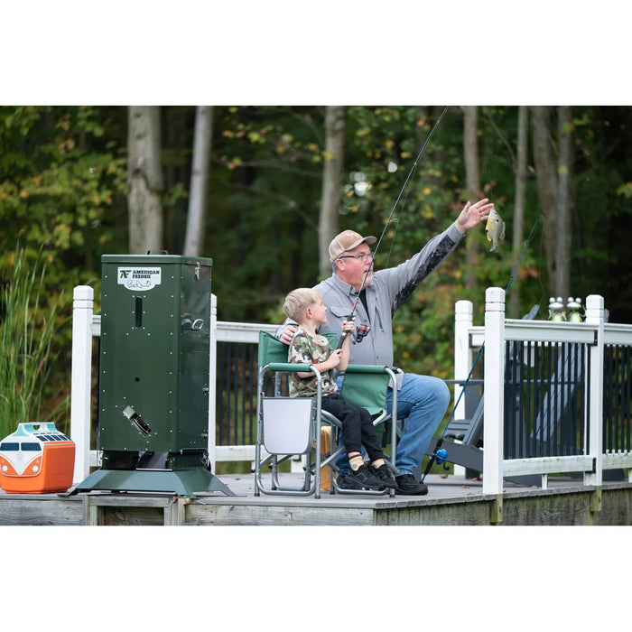 Man and boy fishing from a dock next to the American Feeder H125 Fish Feeder with a fresh caught bluegill