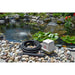 White linear compressor and coiled airline of the Easy Pro LA5W Linear Aeration Kit set beside an aerated pond