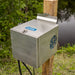 Kasco Marine Home Series Diffused Aerator cabinet mounted on a wooden post with bracket beside a pond