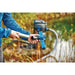 Person fitting the wide blue universal floor nozzle to the Oase PondoVac 5 pole beside a pond