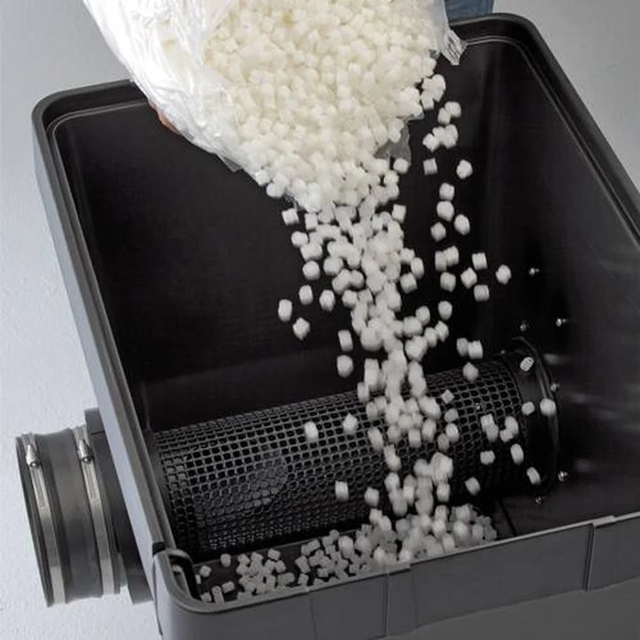 Pouring white bio-media into the open tank of the Oase ProfiClear Premium Moving Bed Module Bio Filter
