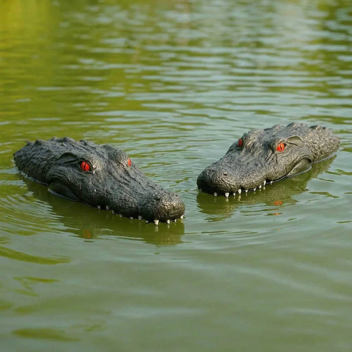 Two floating alligator head decoy markers used with the Outdoor Water Solutions Steel Windmill Aerator 4 Leg Tower