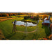 Aerial farm view of three Outdoor Water Solutions 4 Leg Windmill Pond Aerator towers around a pond in autumn