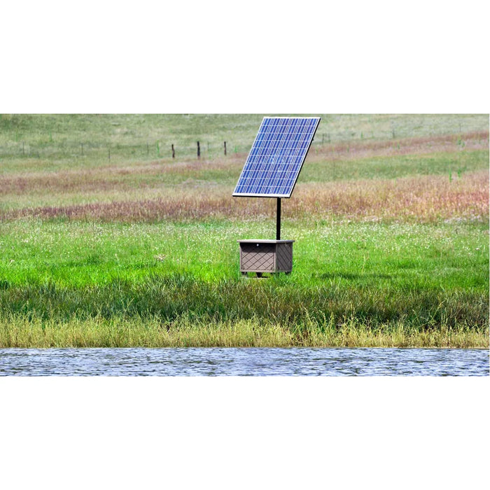 ProLake Solaer 1.2 Pond Aerator installed beside a pond with solar panel on a mounting pole in a grassy field